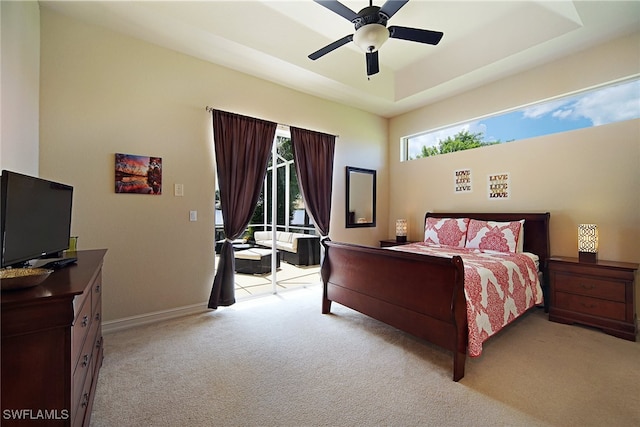 bedroom featuring access to outside, light carpet, baseboards, ceiling fan, and a raised ceiling