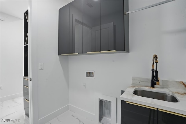 35 Chiquita Blvd N, Cape Coral, FL 33993 - laundry room featuring cabinet space, hookup for a washing machine, light marble finish flooring, and baseboards
