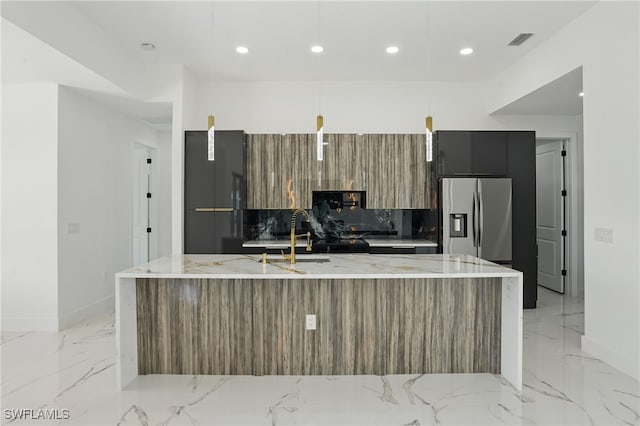 35 Chiquita Blvd N, Cape Coral, FL 33993 - kitchen featuring modern cabinets, stainless steel refrigerator with ice dispenser, a large island with sink, light marble finish floors, and recessed lighting