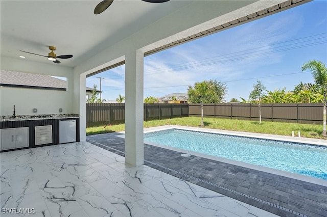 35 Chiquita Blvd N, Cape Coral, FL 33993 - view of pool featuring area for grilling, ceiling fan, a fenced backyard, a sink, and a patio