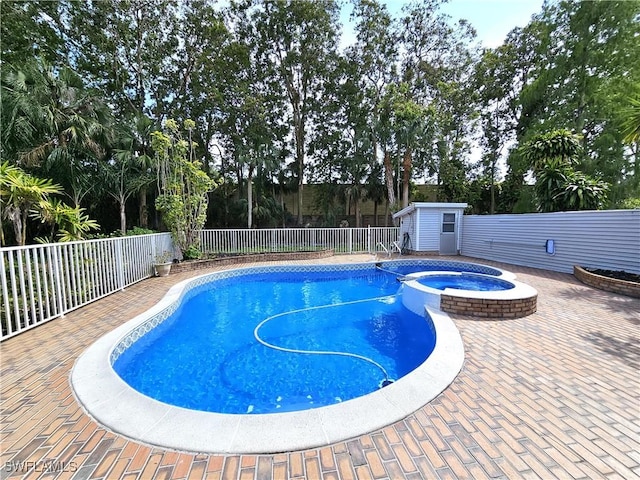 1431 Monarch Cir Unit B8, Naples, FL 34116 - view of pool with a fenced backyard, an outbuilding, a pool with connected hot tub, a storage unit, and view of wooded area