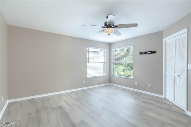 1431 Monarch Cir Unit B8, Naples, FL 34116 - unfurnished bedroom with light wood-type flooring, baseboards, a ceiling fan, and a closet
