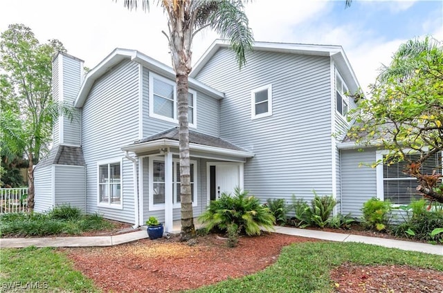 1431 Monarch Cir Unit B8, Naples, FL 34116 - view of front of property with a chimney and a shingled roof