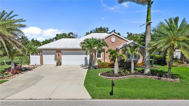 16232 Quesa Dr, Punta Gorda, FL 33955 - view of front of house featuring concrete driveway, an attached garage, a front lawn, and stucco siding