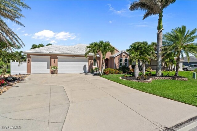 16232 Quesa Dr, Punta Gorda, FL 33955 - ranch-style house with stucco siding, concrete driveway, an attached garage, and a tiled roof