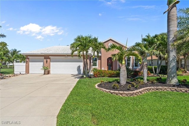 16232 Quesa Dr, Punta Gorda, FL 33955 - view of front of property with driveway, a garage, a front yard, and stucco siding