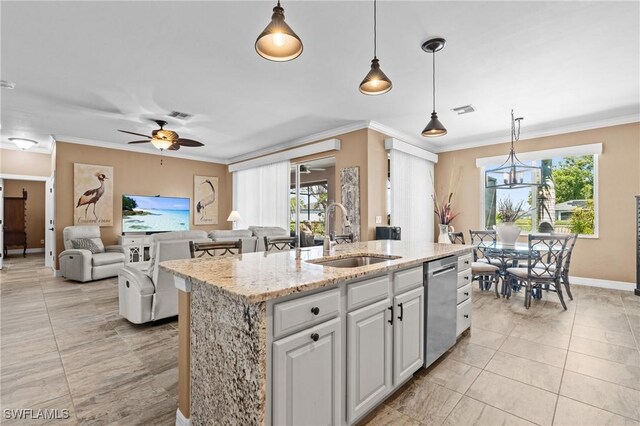 16232 Quesa Dr, Punta Gorda, FL 33955 - kitchen featuring a sink, stainless steel dishwasher, a center island with sink, ornamental molding, and light stone countertops