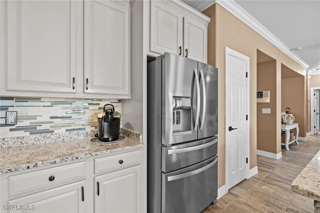 16232 Quesa Dr, Punta Gorda, FL 33955 - kitchen featuring stainless steel fridge with ice dispenser, crown molding, tasteful backsplash, baseboards, and light stone countertops