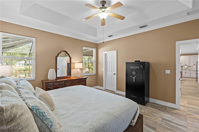 16232 Quesa Dr, Punta Gorda, FL 33955 - bedroom featuring a tray ceiling, ornamental molding, a ceiling fan, and baseboards