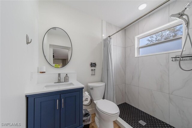 1300 Hilltop Dr, Naples, FL 34103 - bathroom featuring a tile shower, vanity, and toilet
