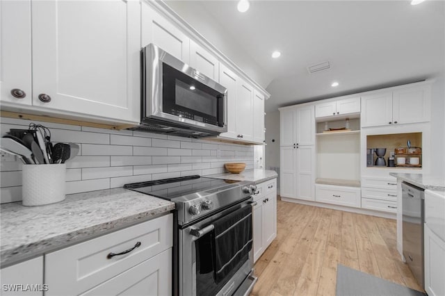 1300 Hilltop Dr, Naples, FL 34103 - kitchen with appliances with stainless steel finishes, open shelves, recessed lighting, white cabinetry, and tasteful backsplash