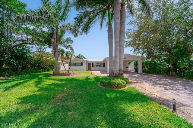 1300 Hilltop Dr, Naples, FL 34103 - view of front facade featuring decorative driveway, a front yard, and an attached carport