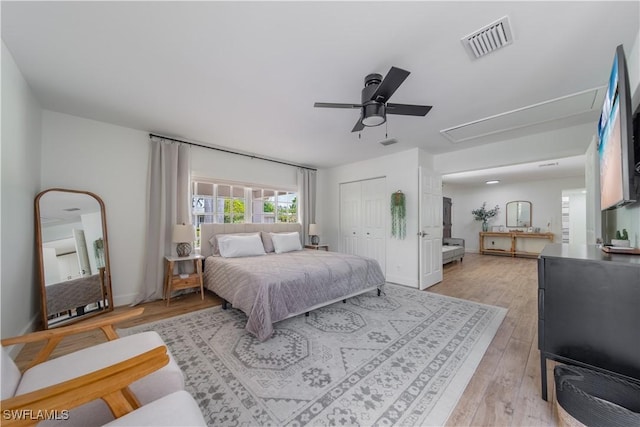 1300 Hilltop Dr, Naples, FL 34103 - bedroom featuring light wood-style flooring, attic access, a closet, ceiling fan, and baseboards