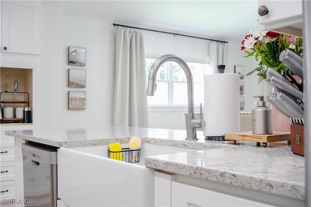 1300 Hilltop Dr, Naples, FL 34103 - kitchen view of white cabinets, light stone counters, and stainless steel dishwasher