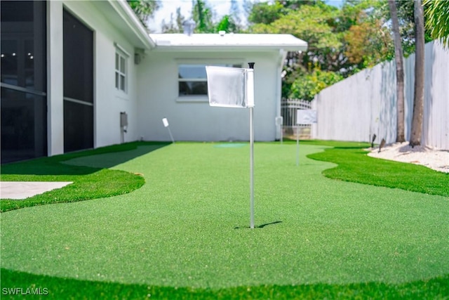 1300 Hilltop Dr, Naples, FL 34103 - view of yard featuring fence and a putting area