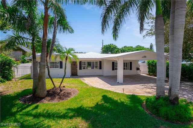 1300 Hilltop Dr, Naples, FL 34103 - rear view of property with stucco siding, a carport, metal roof, and a patio