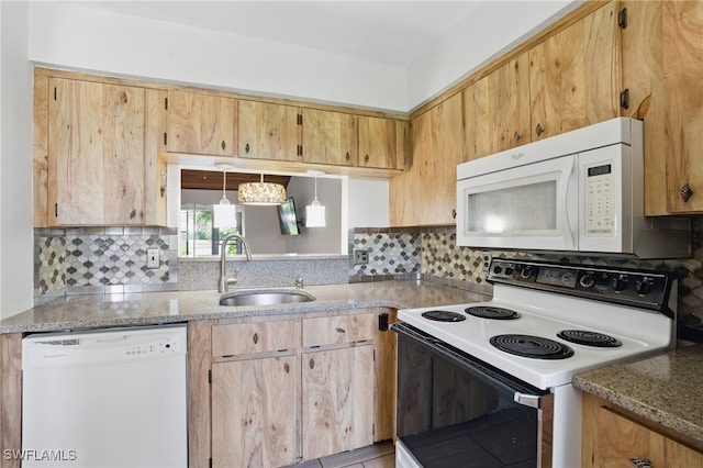 kitchen featuring white appliances, a sink, tasteful backsplash, and light stone countertops