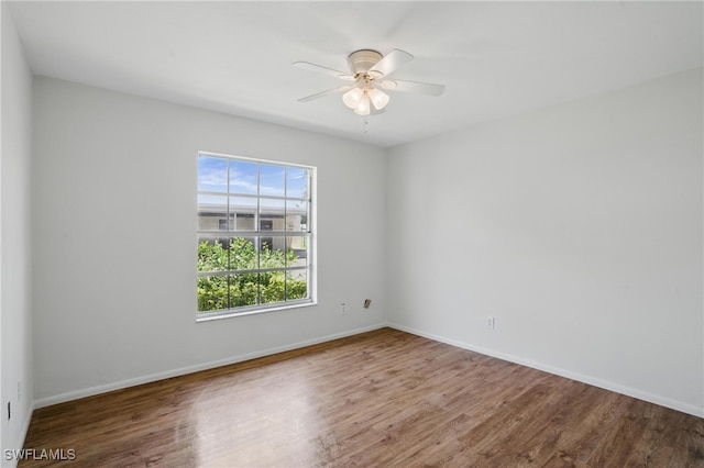 unfurnished room featuring wood finished floors, ceiling fan, and baseboards