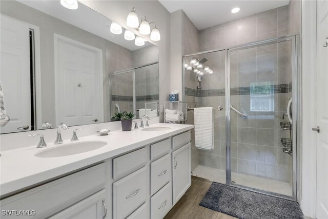 1256 Enbrook Loop, Naples, FL 34114 - bathroom with double vanity, a stall shower, wood finished floors, and recessed lighting