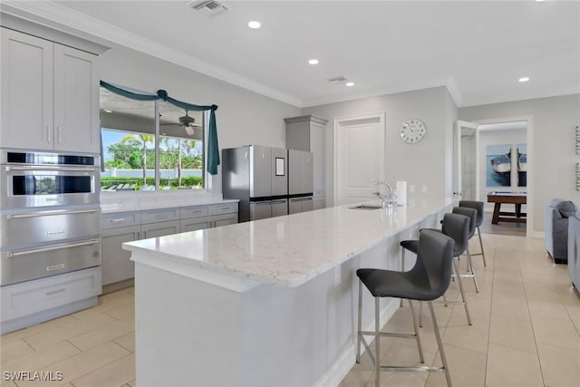 1256 Enbrook Loop, Naples, FL 34114 - kitchen with stainless steel appliances, a warming drawer, gray cabinets, a sink, and ornamental molding