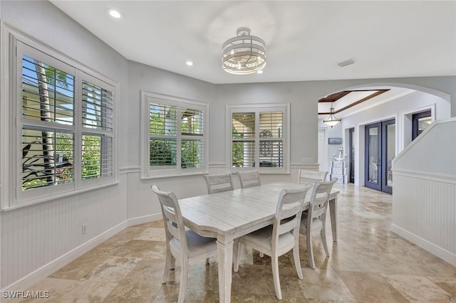 1817 Piccadilly Cir, Cape Coral, FL 33991 - dining area with arched walkways, wainscoting, a chandelier, recessed lighting, and baseboards