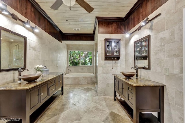 1817 Piccadilly Cir, Cape Coral, FL 33991 - bathroom with tile walls, a ceiling fan, a bath, two vanities, and wood ceiling