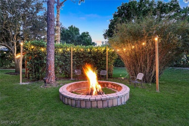1817 Piccadilly Cir, Cape Coral, FL 33991 - view of green lawn featuring an outdoor fire pit