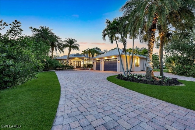 1817 Piccadilly Cir, Cape Coral, FL 33991 - view of front of home featuring a lawn, a garage, and decorative driveway