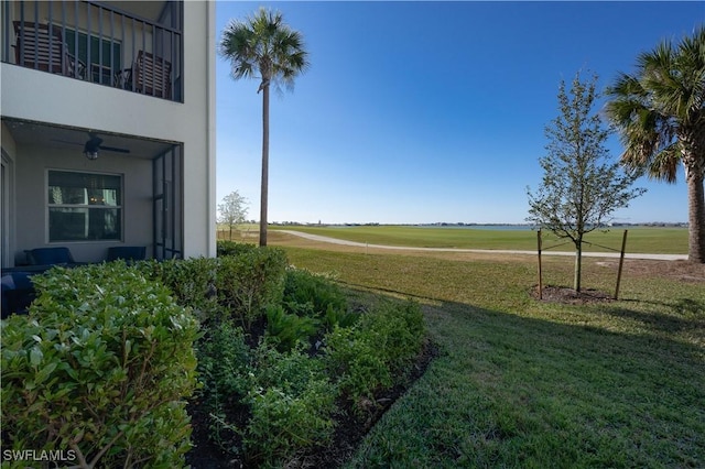 43030 Greenway Blvd Unit 417, Punta Gorda, FL 33982 - view of grassy yard featuring a balcony and a ceiling fan