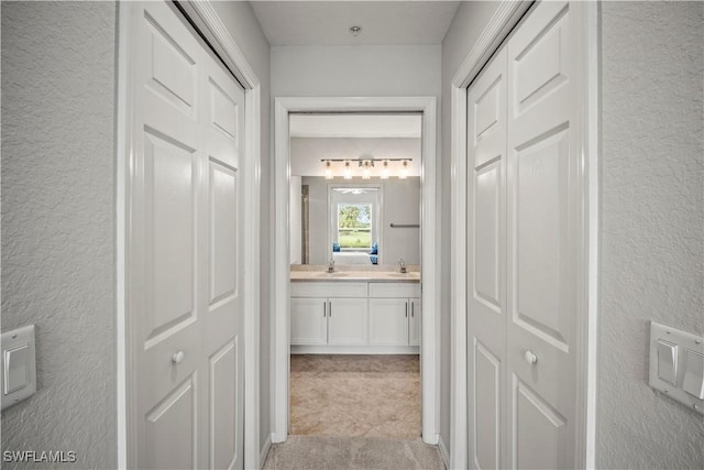 10260 Heritage Bay Blvd Unit 3515, Naples, FL 34120 - hall with a sink and a textured wall