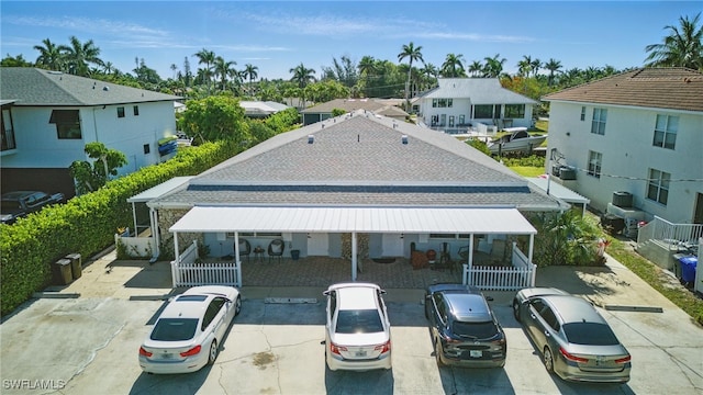1185 Cherrystone Ct Unit A, Naples, FL 34102 - rear view of house with a residential view, uncovered parking, fence, and a patio
