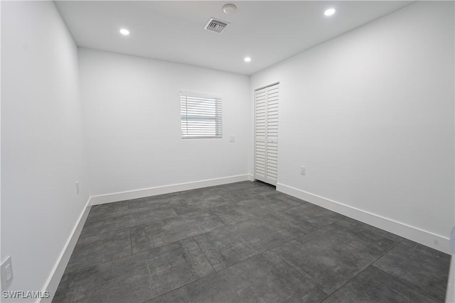 2564 Poinciana St, Naples, FL 34105 - empty room with recessed lighting, baseboards, and concrete flooring