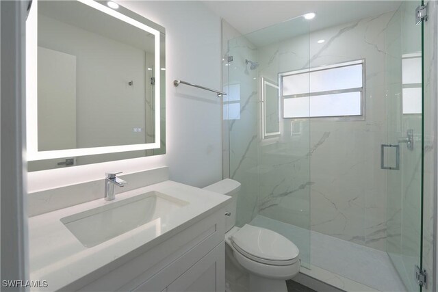 2564 Poinciana St, Naples, FL 34105 - bathroom with a marble finish shower, toilet, and vanity