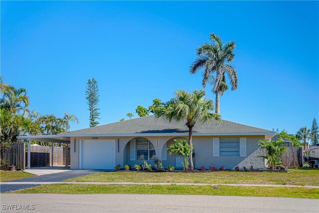 2564 Poinciana St, Naples, FL 34105 - ranch-style house featuring stucco siding, asphalt driveway, an attached carport, and a garage