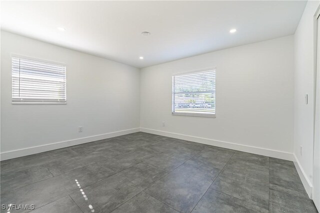 2564 Poinciana St, Naples, FL 34105 - unfurnished room featuring baseboards, concrete flooring, and recessed lighting