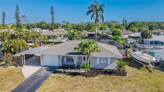 2564 Poinciana St, Naples, FL 34105 - single story home with driveway, an attached carport, a residential view, and stucco siding