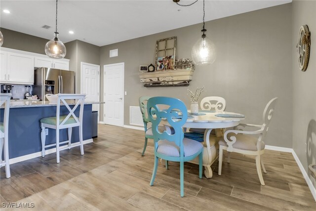 11711 Pasetto Ln Unit 407, Fort Myers, FL 33908 - dining room with light wood-style floors, recessed lighting, and baseboards