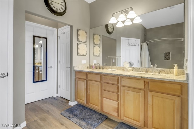 11711 Pasetto Ln Unit 407, Fort Myers, FL 33908 - full bath with wood finished floors, curtained shower, and double vanity