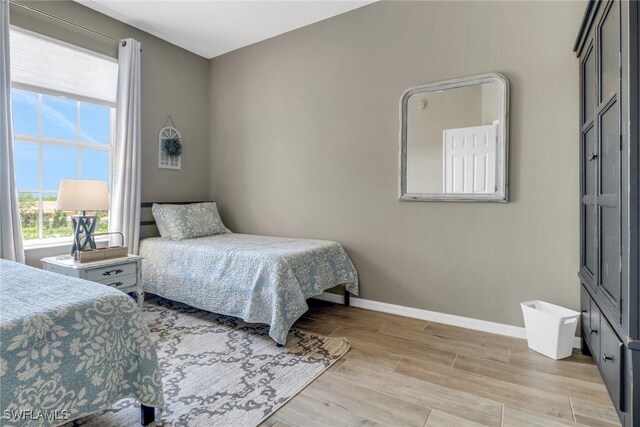 11711 Pasetto Ln Unit 407, Fort Myers, FL 33908 - bedroom featuring baseboards and light wood-type flooring