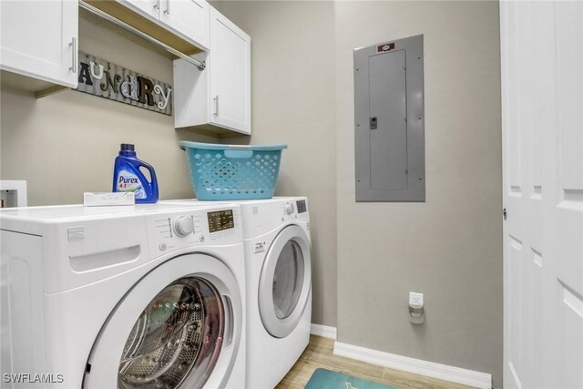11711 Pasetto Ln Unit 407, Fort Myers, FL 33908 - laundry area featuring electric panel, cabinet space, washer and clothes dryer, baseboards, and light wood-type flooring
