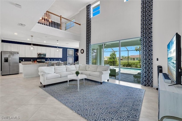 2369 Tangerine Ln, Naples, FL 34120 - living room with a towering ceiling, light tile patterned floors, plenty of natural light, and crown molding