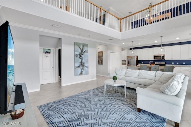2369 Tangerine Ln, Naples, FL 34120 - living area featuring a towering ceiling, ornamental molding, baseboards, light tile patterned floors, and recessed lighting