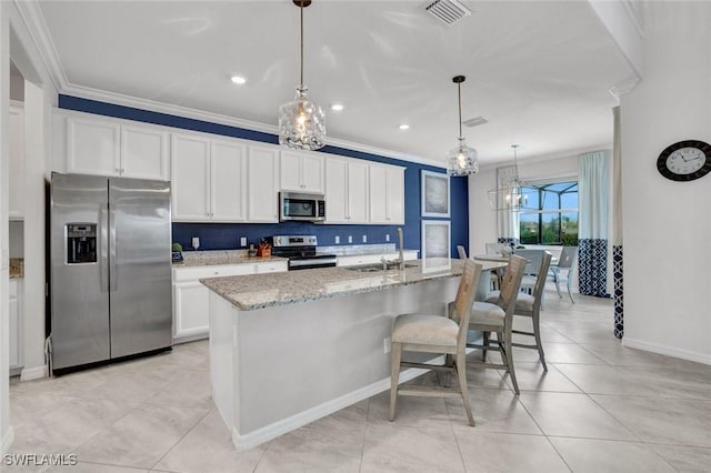 2369 Tangerine Ln, Naples, FL 34120 - kitchen featuring appliances with stainless steel finishes, a sink, crown molding, a kitchen island with sink, and white cabinetry