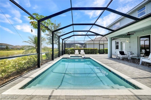 2369 Tangerine Ln, Naples, FL 34120 - view of pool with a patio, a ceiling fan, a pool with connected hot tub, a lanai, and a water view