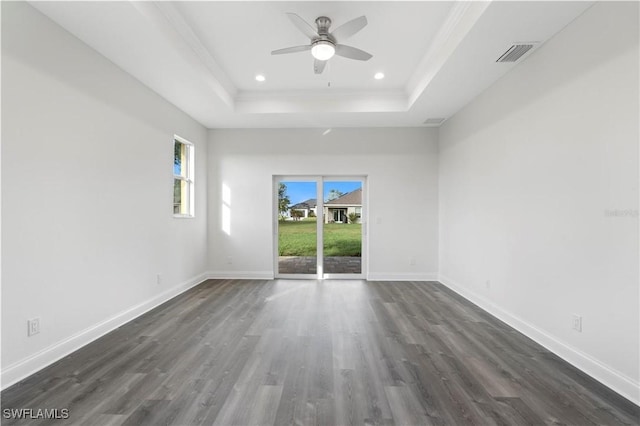 16077 Coruna Ct, Punta Gorda, FL 33955 - spare room featuring a tray ceiling, dark wood-style floors, ceiling fan, baseboards, and recessed lighting