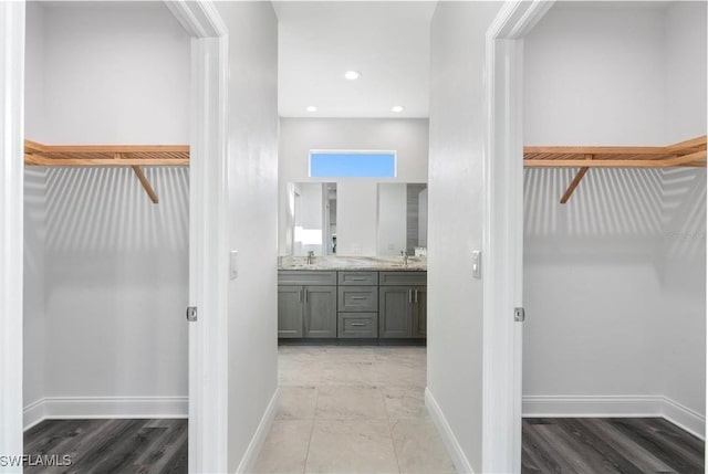16077 Coruna Ct, Punta Gorda, FL 33955 - hall with a sink, baseboards, light wood-type flooring, and recessed lighting