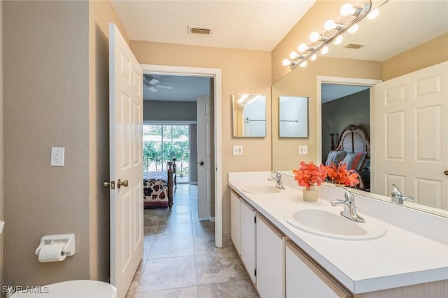 6461 Aragon Way Unit 102, Fort Myers, FL 33966 - ensuite bathroom featuring double vanity, tile patterned flooring, ceiling fan, and baseboards
