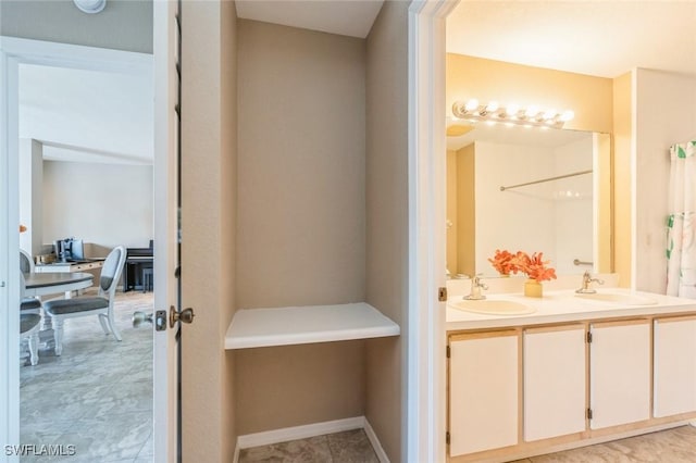 6461 Aragon Way Unit 102, Fort Myers, FL 33966 - bathroom featuring double vanity and baseboards