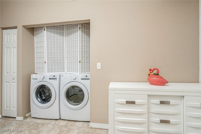 6461 Aragon Way Unit 102, Fort Myers, FL 33966 - washroom with washer and clothes dryer, light tile patterned flooring, and baseboards