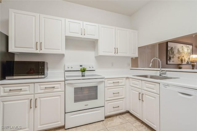 6461 Aragon Way Unit 102, Fort Myers, FL 33966 - kitchen with white appliances, light countertops, white cabinetry, a sink, and light tile patterned floors